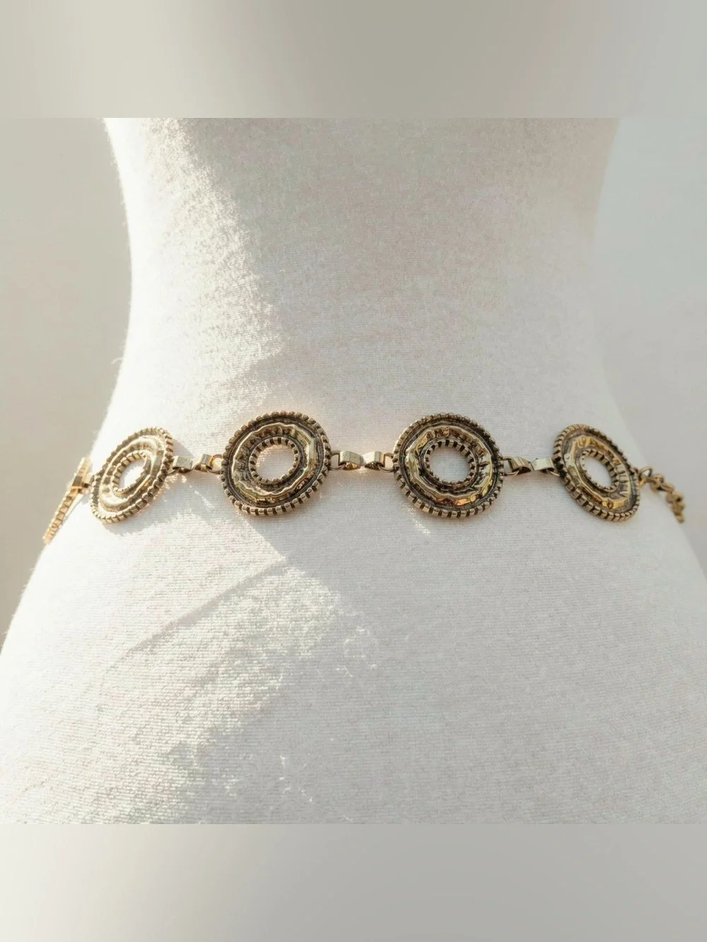 Gold tone metal belt with brass chain, metal circles and metal ball details